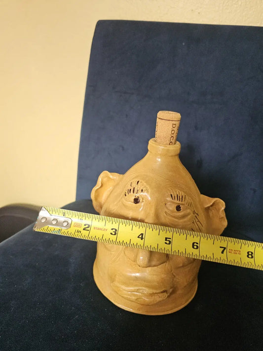 Vintage Art Moonshine jug or handmade clay sculpture a head with a cork